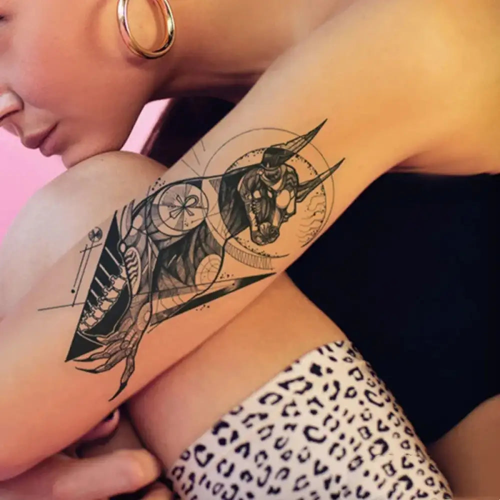 Detailed black and white geometric Doberman tattoo sticker inspired by ancient Egyptian Anubis on arm