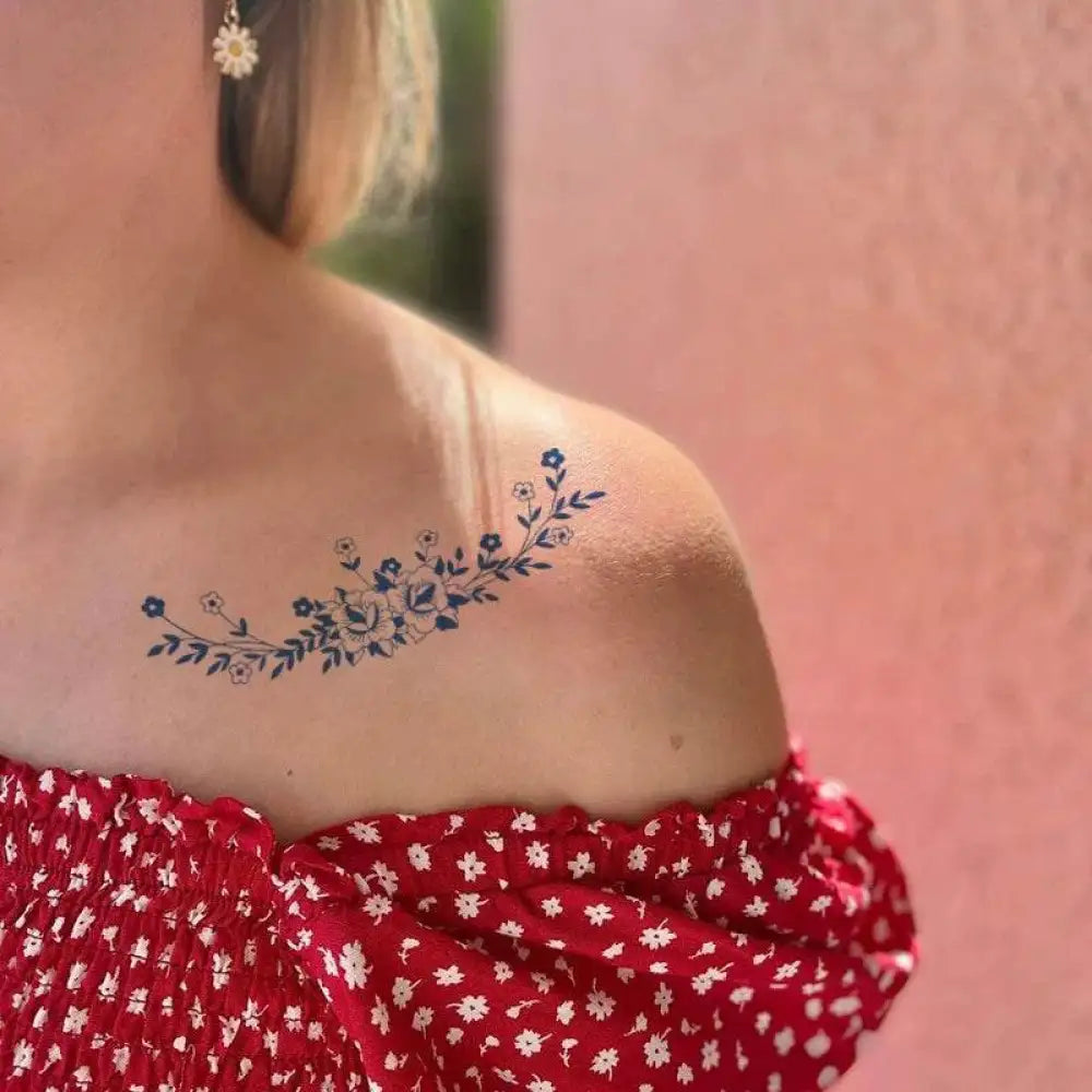 Blue floral tattoo sticker with advanced hand-drawn design on woman’s shoulder, real reviews