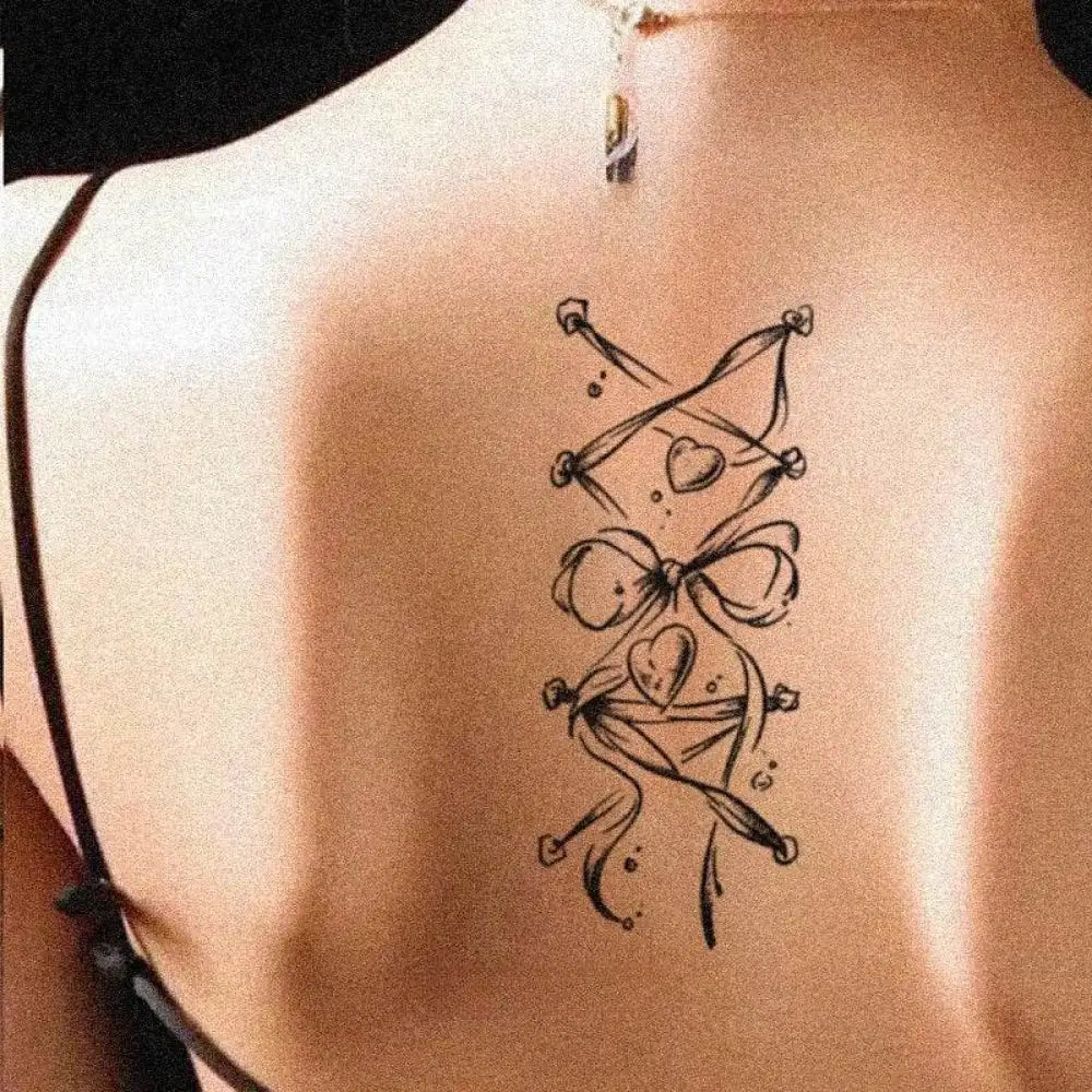 Black corset back tattoo sticker with hearts, bows, and butterfly clasp, 15x6cm