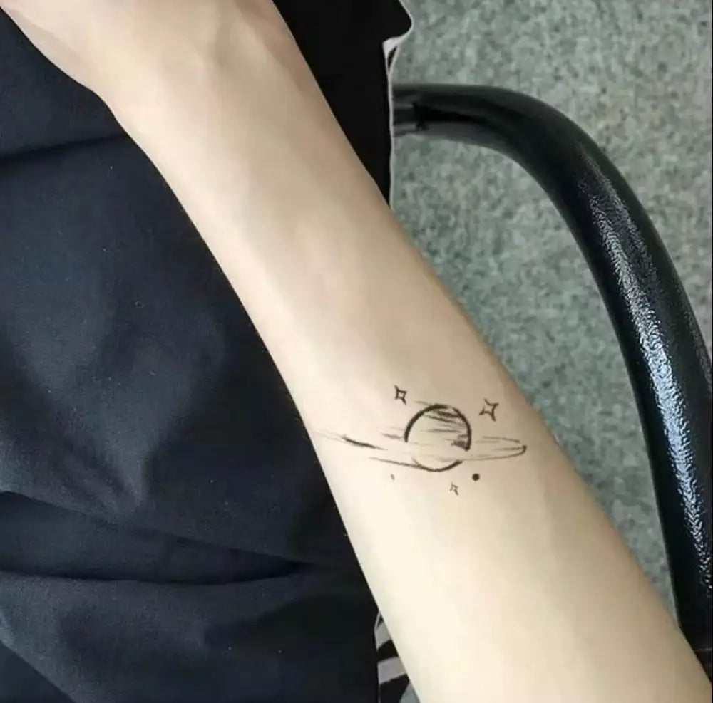 Minimalist semi-permanent planet tattoo sticker on forearm from Jupiter’s Whisper Cosmic Kiss with real reviews