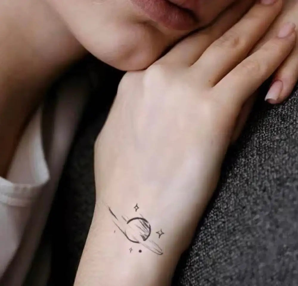 Semi-permanent planet tattoo sticker featuring a celestial body design on the wrist