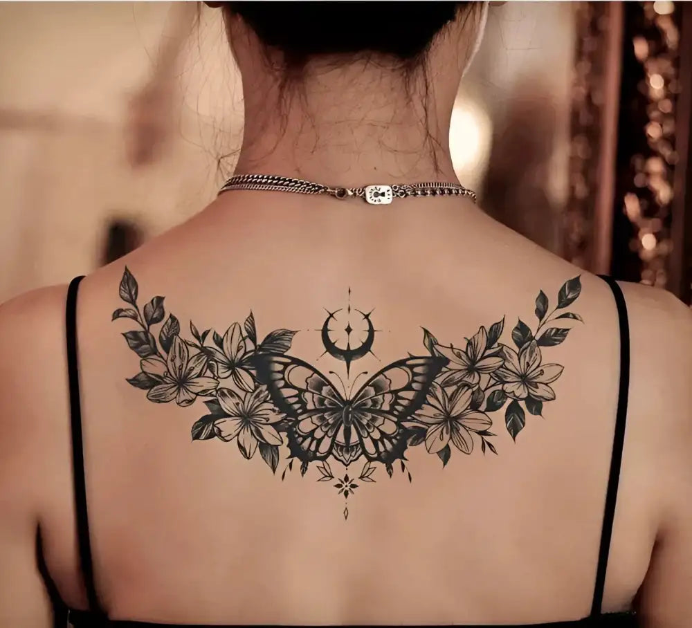 Flowered butterfly temporary tattoo sticker with black floral design on back, 15x6cm