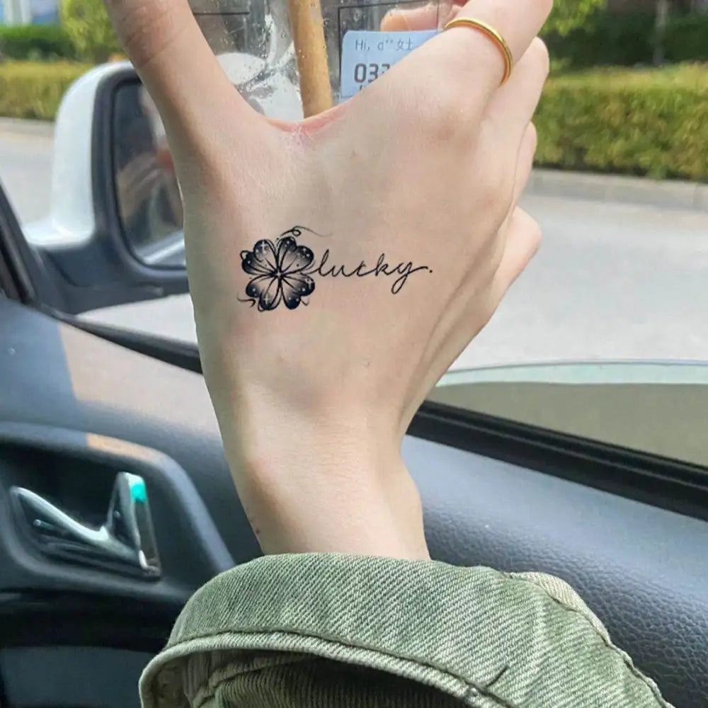 Hand with a lucky four-leaf clover tattoo sticker from Happy Lucky Clover collection