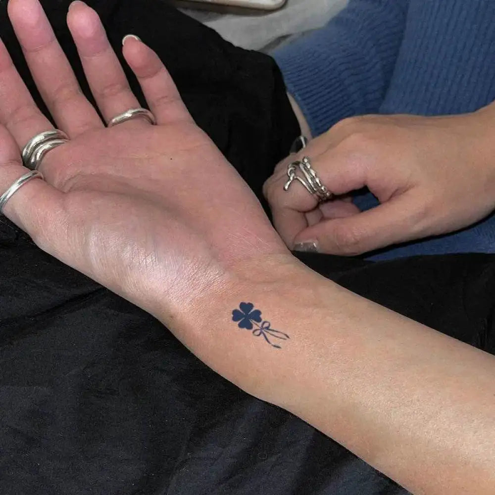 Wrist with small dark blue lucky four-leaf clover tattoo sticker real reviews