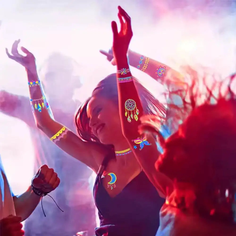 People dancing at party with Night’s Bloom Adornments temporary tattoos