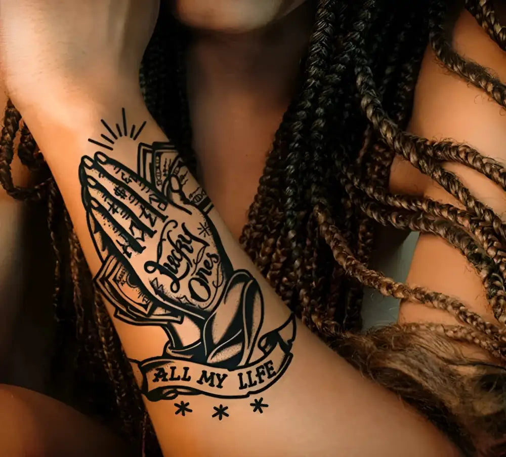 Black and white praying hands with money tattoo sticker on arm, All My Life banner, small tattoo design