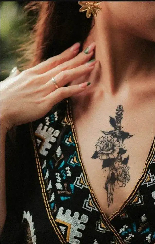 Sword Flower temporary tattoo sticker featuring a woman’s chest with a dark dagger and rose design