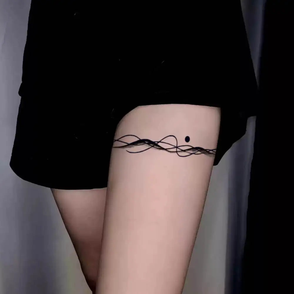 Ethereal Swirling Tendrils semi-permanent tattoo sticker with an advanced hand-drawn black design on thigh