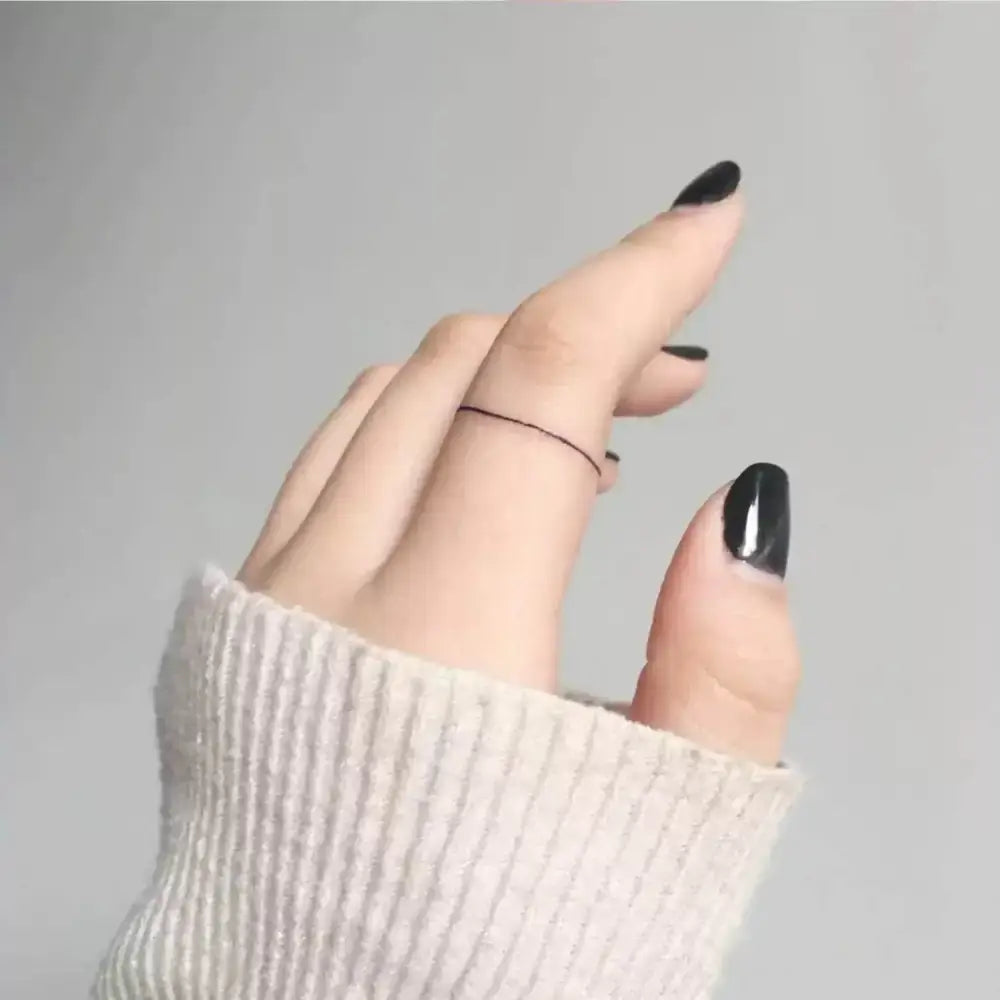 Hand with black nail polish and thin black ring showcasing Advanced Hand-Drawn Black Bow Tattoo Sticker Collection