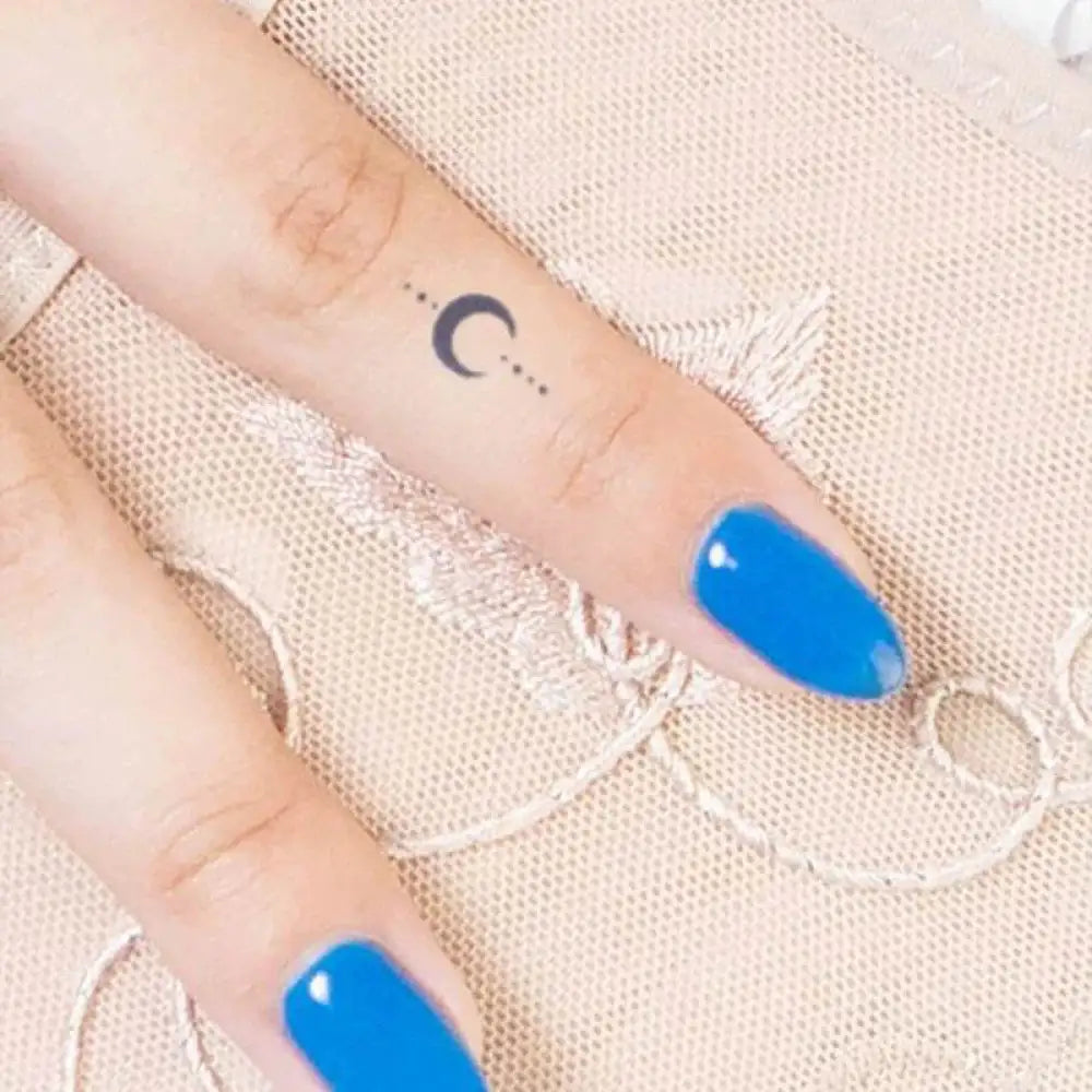 Celestial Tattoo Sticker Collection Under Branches Light Moon with blue nail polish and crescent moon tattoo