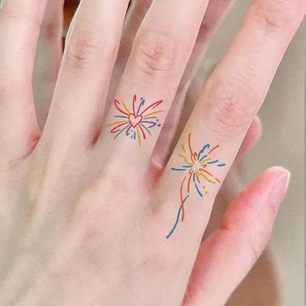 Small rainbow heart and fireworks tattoo sticker designs on fingers