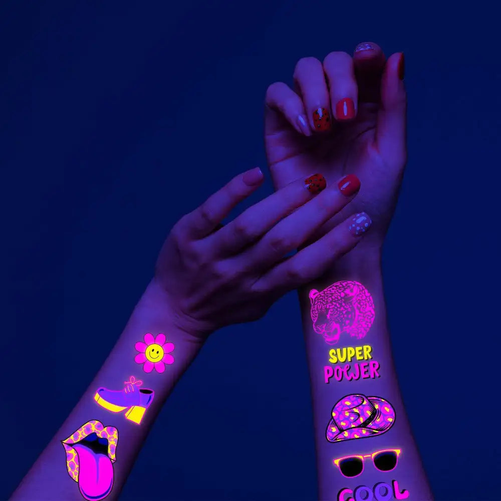 Arms with glow-in-the-dark Dark Graffiti GL temporary tattoos