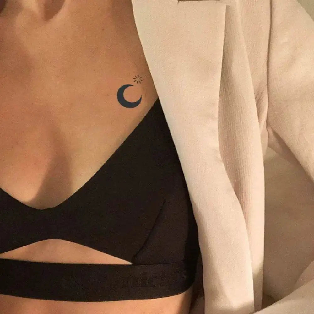 Woman wearing black bralette and beige blazer with dark moon tattoo sticker, real reviews