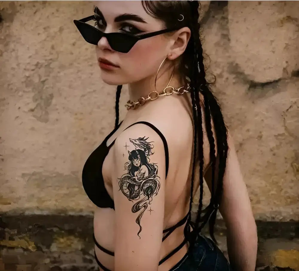 Woman in black bralette and sunglasses with Drakan small temporary tattoo sticker on arm