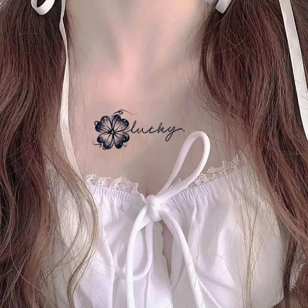 Woman’s chest with happy lucky clover temporary tattoo sticker and lucky clover script