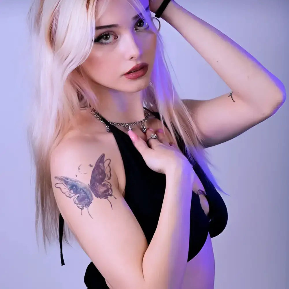 Young woman with long blonde hair showcasing Iridescent Chrysalis tattoo sticker with advanced hand-drawn design