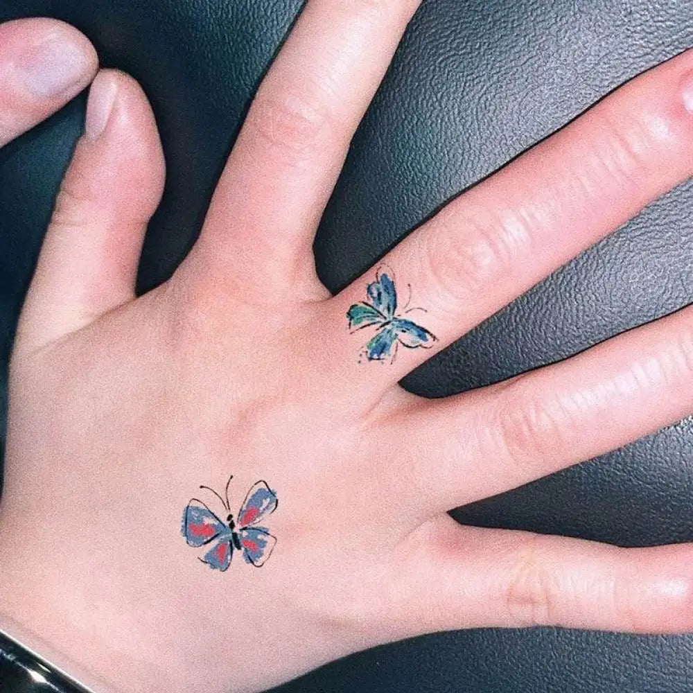 Small Iris Japonica temporary tattoo sticker on hand, 1x1 cm butterfly design