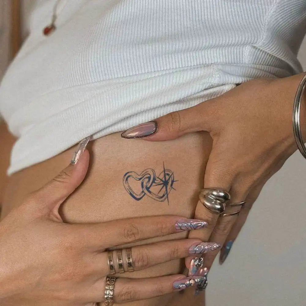 Loving Stars tattoo sticker featuring intertwined hearts and starburst design