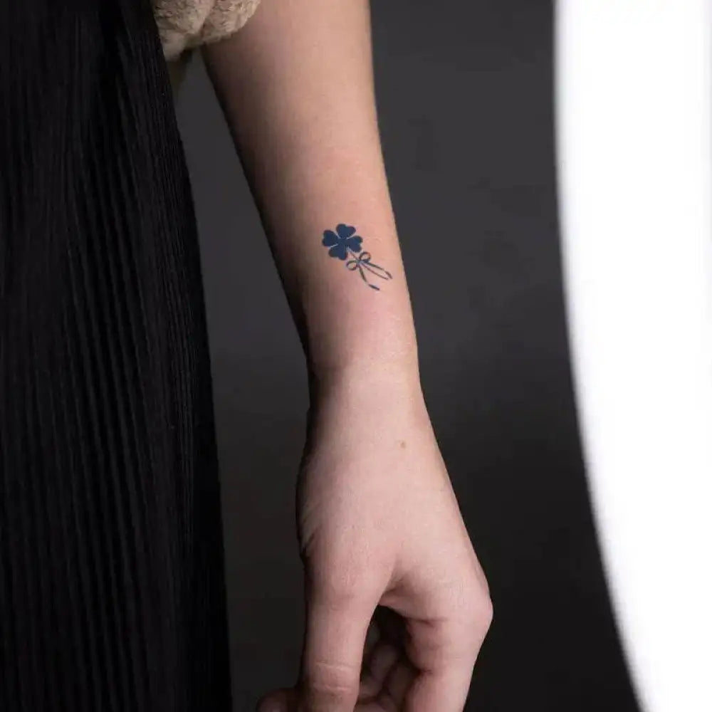 Forearm with lucky four-leaf clover tattoo sticker tied with ribbon, real reviews