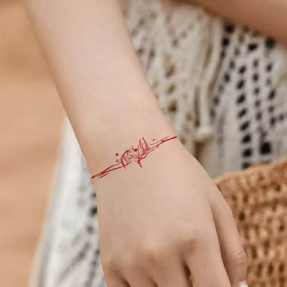 Red string bracelet with butterfly design from Mermaid Dreams tattoo sticker collection