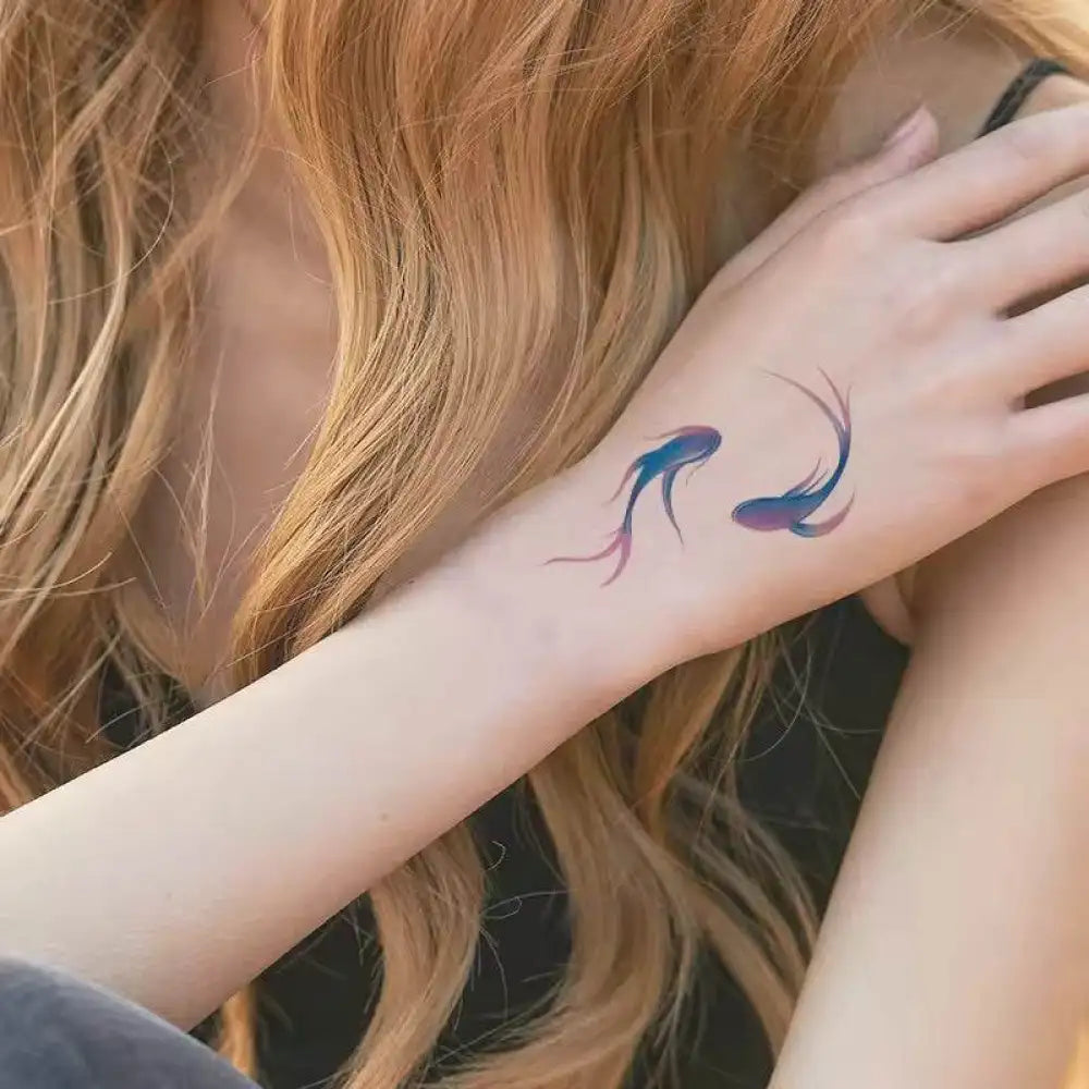 Mermaid Dreams tattoo sticker showcasing colorful fish tattoos on woman’s arm with real reviews