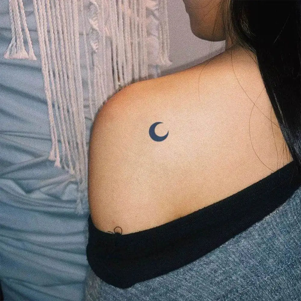 Close-up of shoulder with dark crescent moon tattoo sticker from Advanced Hand-Drawn Design Guide