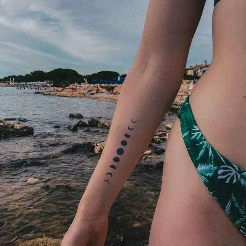 Person wearing green bikini bottom with moon phase tattoo sticker and real reviews
