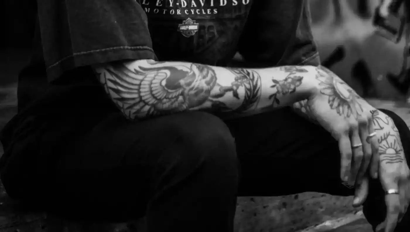 A person with tattooed arms and hands.